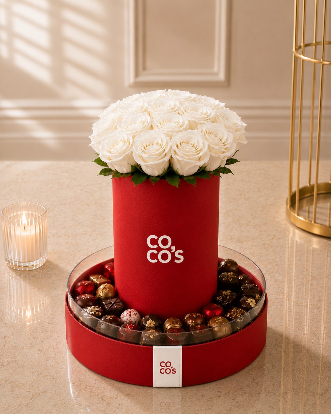 Red Coco's box with a dome of white roses and a ring of Belgian pralines